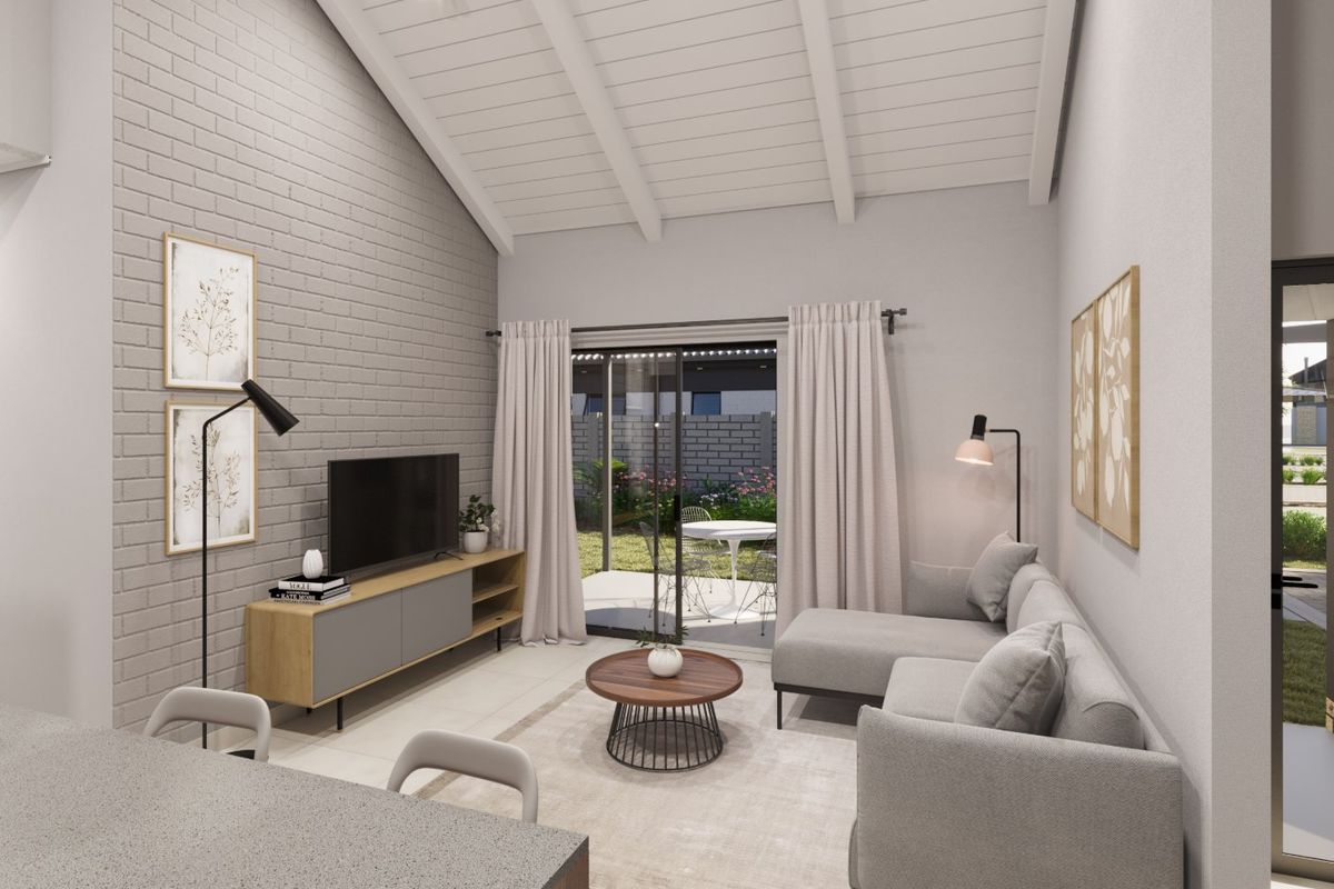 Modern living room featuring a vaulted ceiling with exposed rafters, an exposed brick feature wall, and sliding glass doors leading to the patio.