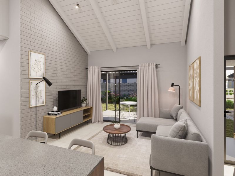 Modern living room featuring a vaulted ceiling with exposed rafters, an exposed brick feature wall, and sliding glass doors leading to the patio.