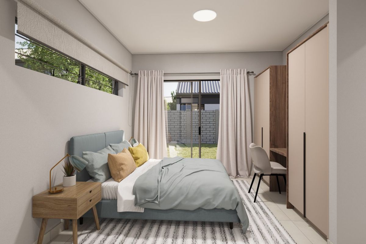 Modern bedroom featuring built-in cupboards, a sleek desk area, and a sliding glass door providing direct access to the garden.