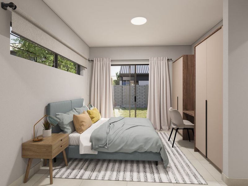 Modern bedroom featuring built-in cupboards, a sleek desk area, and a sliding glass door providing direct access to the garden.