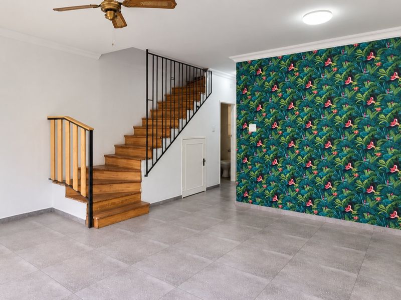 Spacious living area featuring modern grey floor tiles, a wooden staircase with metal railing, and a decorative feature wall.