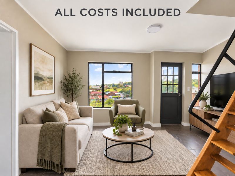 A bright and modern living room featuring tiled floors, large windows with scenic views, and direct access to an exterior door.