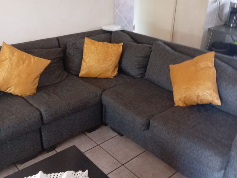 A living room area featuring tiled flooring, providing a functional space for relaxation.