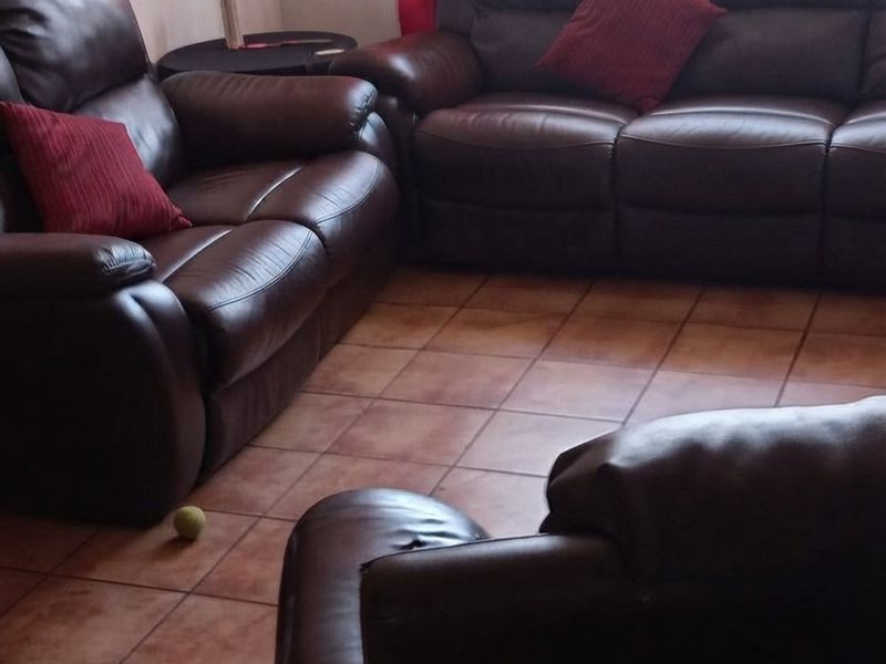 A living room area featuring ceramic floor tiles, providing a functional space for relaxation.