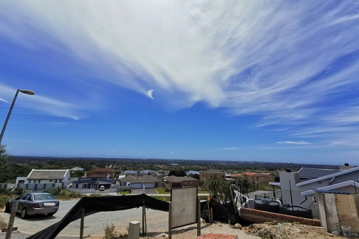Elevated view overlooking the surrounding residential neighbourhood and landscape from the vacant land plot.