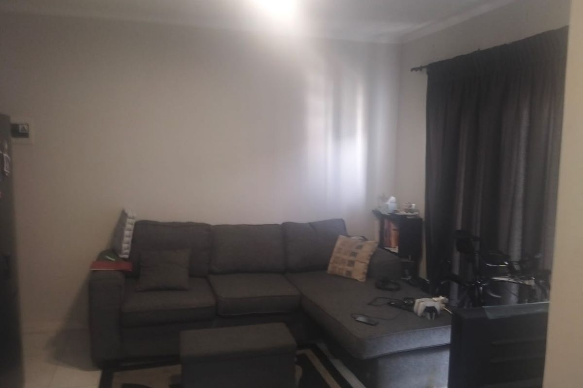 A living room area featuring tiled flooring and curtain rails, providing a neutral base for interior design updates.