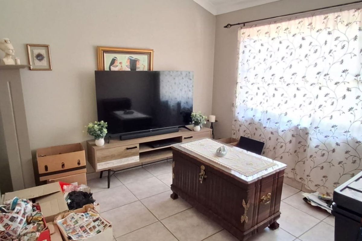 A living room featuring tiled flooring and a coved ceiling, offering a functional space ready for personalization and updated interior design.