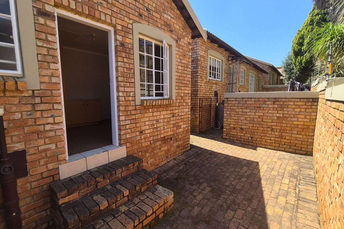A private rear courtyard featuring face brick construction, paved flooring, and secure access points, providing a low-maintenance outdoor space.