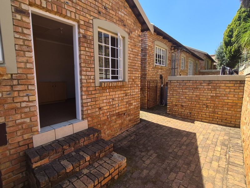 A private rear courtyard featuring face brick construction, paved flooring, and secure access points, providing a low-maintenance outdoor space.