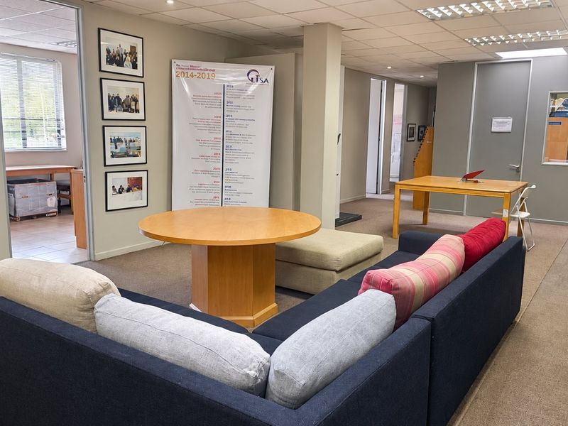 Open-plan commercial office space featuring carpeted flooring, suspended ceilings with recessed lighting, and internal partitioning, suitable for a collaborative work environment.