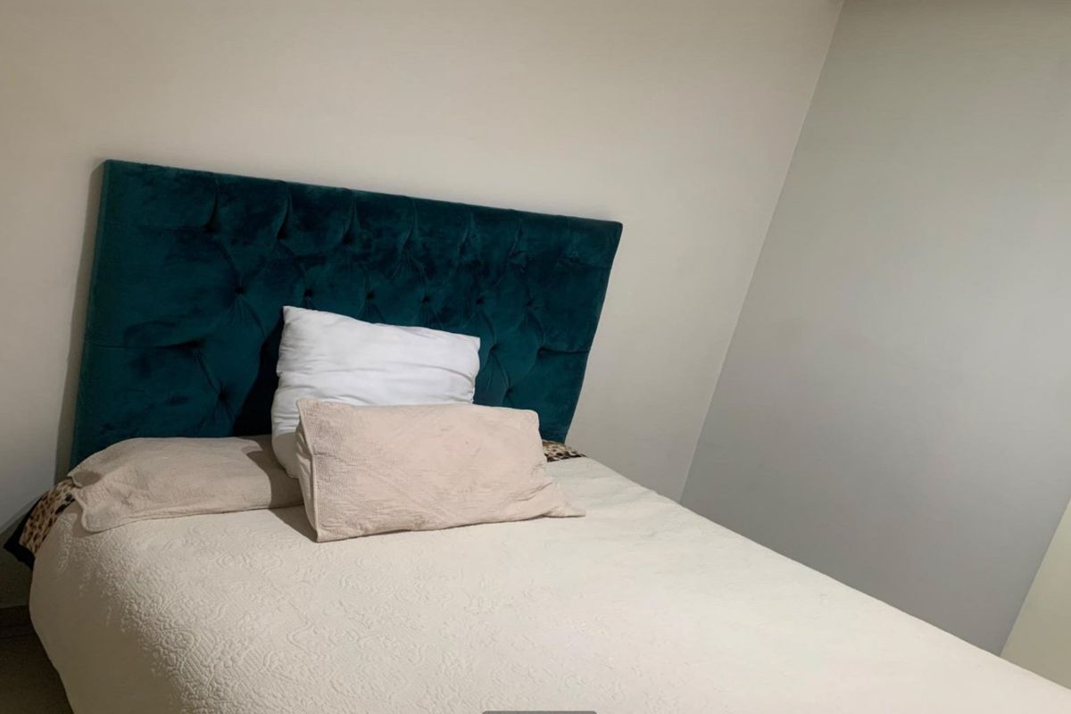 A bedroom featuring neutral wall finishes and a simple layout, suitable for personalization.