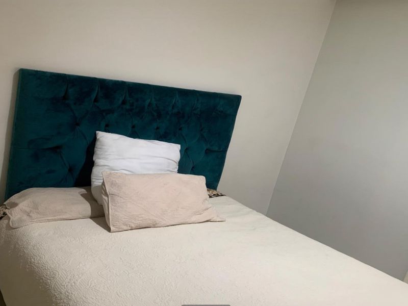 A bedroom featuring neutral wall finishes and a simple layout, suitable for personalization.