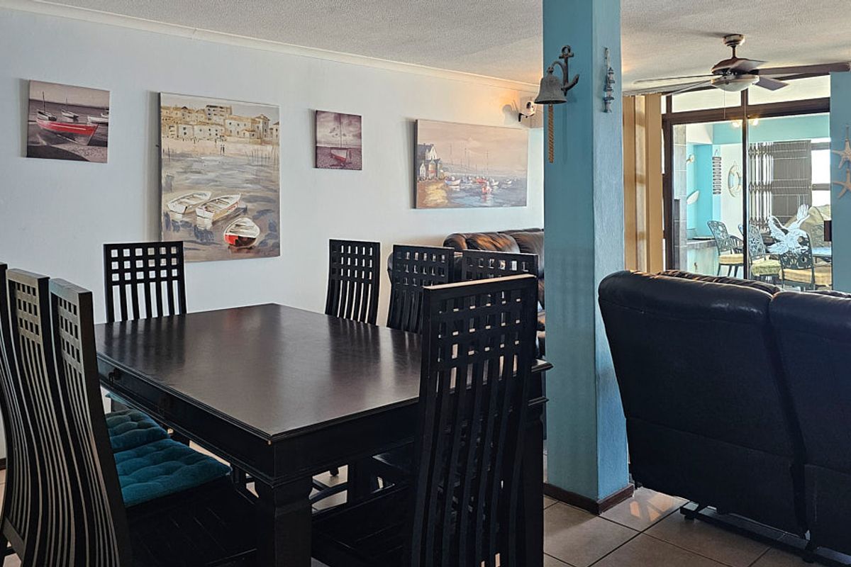 Open plan living and dining area featuring tiled flooring, a ceiling fan, and sliding glass doors leading to an outdoor balcony space.