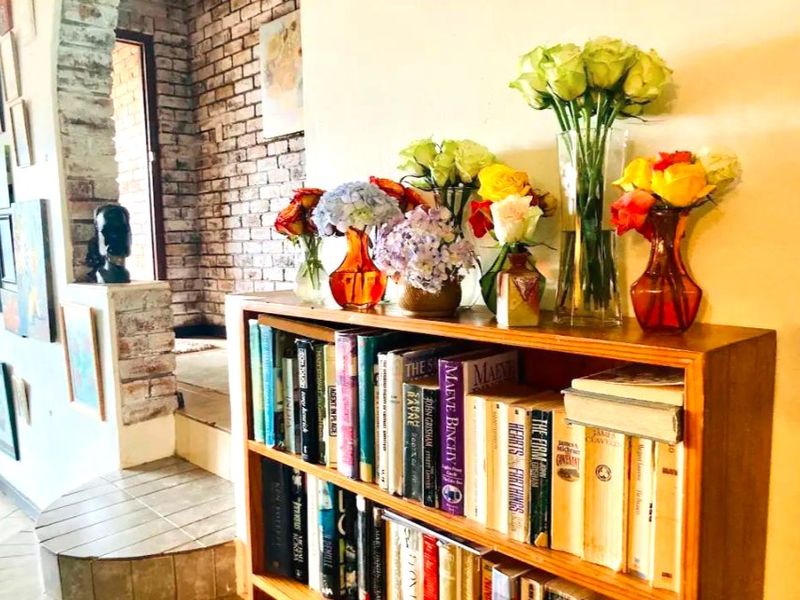 A hallway area featuring an exposed brick wall and tiled flooring, providing a rustic architectural element to the home's transition space.