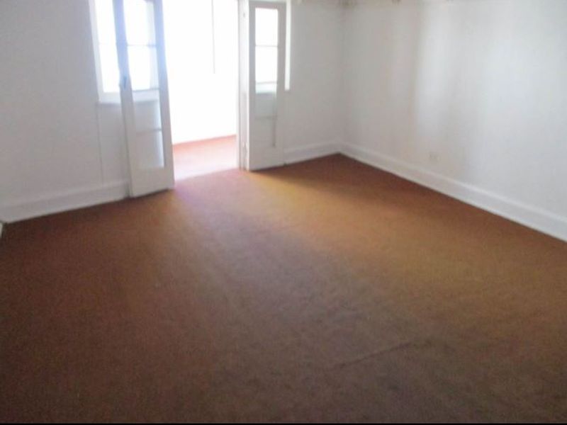 An empty living room featuring original picture rails, carpet flooring, and french doors leading to an adjacent space.
