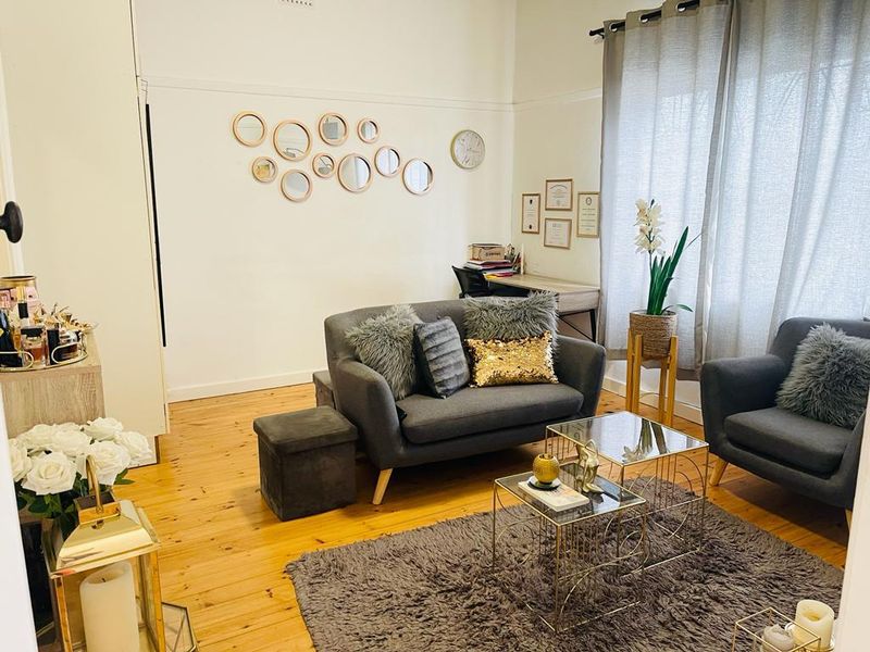 A cozy living room featuring polished timber flooring and a classic picture rail, providing a warm and inviting atmosphere.