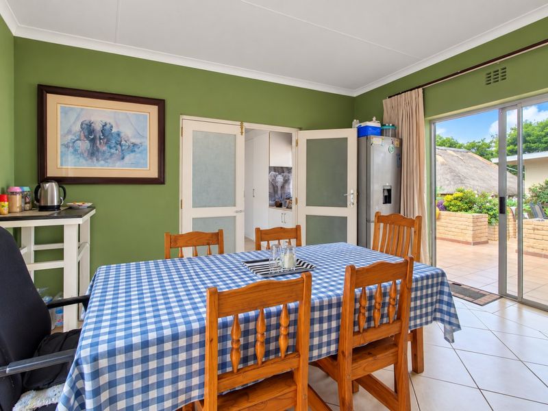 Dining room featuring tiled flooring, coved ceilings, and direct access to an outdoor patio area through sliding glass doors.