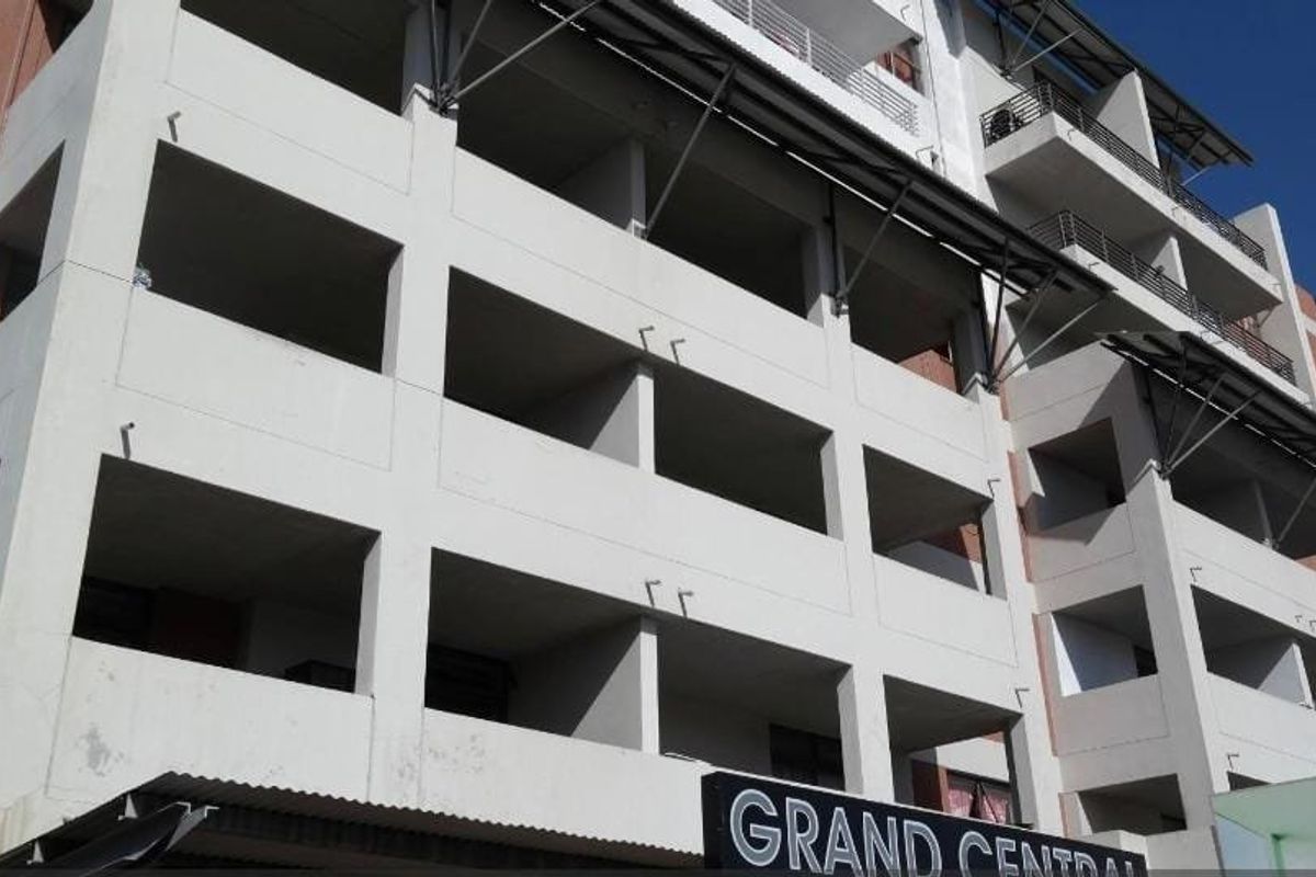 Exterior view of the Grand Central apartment building, showcasing the multi-level facade with integrated balconies and structural metal supports.