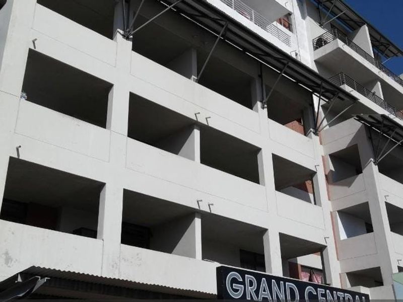 Exterior view of the Grand Central apartment building, showcasing the multi-level facade with integrated balconies and structural metal supports.