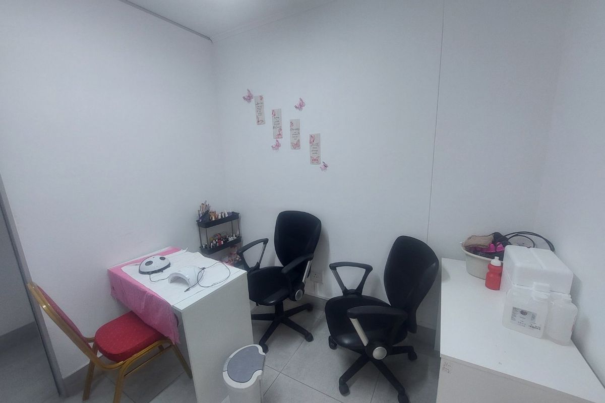 A functional commercial office or treatment room featuring tiled flooring and neutral wall finishes, suitable for various professional service applications.