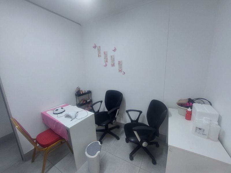 A functional commercial office or treatment room featuring tiled flooring and neutral wall finishes, suitable for various professional service applications.
