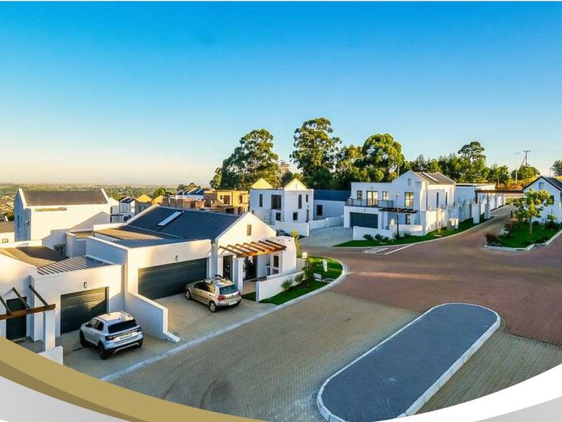 Aerial view of a modern residential estate featuring paved driveways, garages, and well-maintained architectural exteriors.