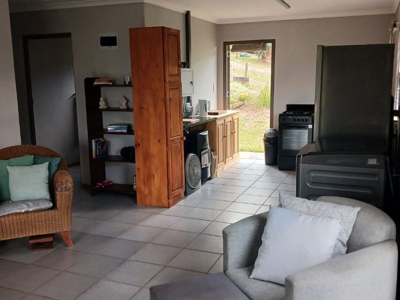 Open plan living and kitchen area featuring tiled flooring, recessed lighting, and direct access to the exterior.