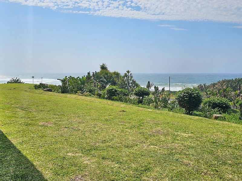 A scenic view of the ocean and landscaped garden area from the property.