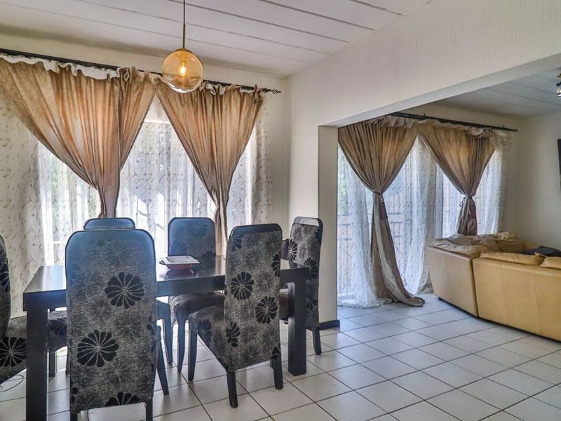 Open plan living and dining area featuring tiled flooring and neutral wall finishes, providing a functional space for daily living and entertaining.