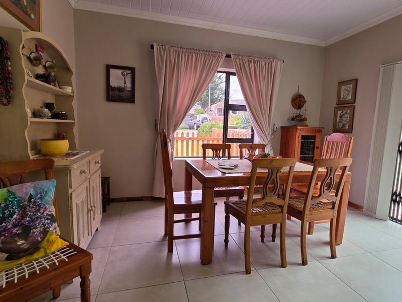 Dining room featuring tiled flooring and a sliding door with security gate providing access to the outdoor area.