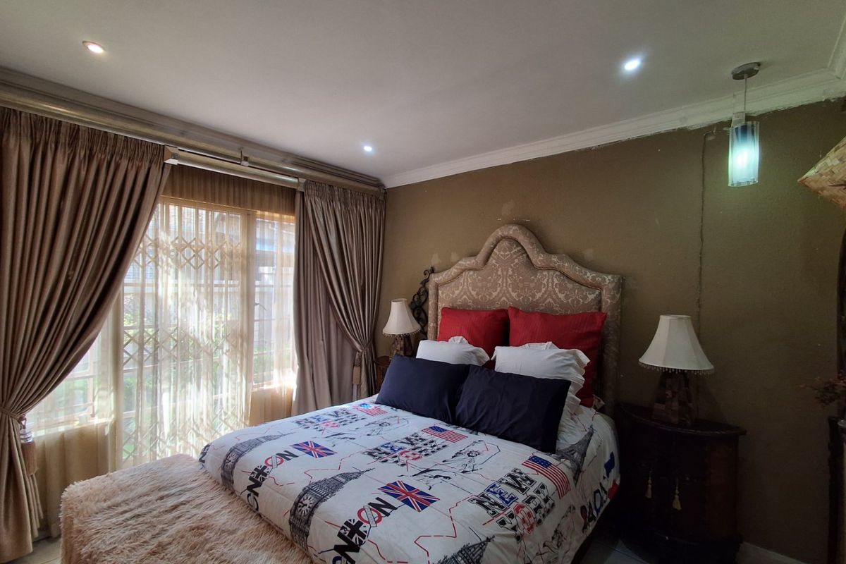 A bedroom featuring recessed lighting, coving, and a sliding glass door with security gate, providing access to the exterior.