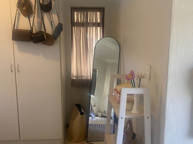 A bedroom corner featuring a built-in wardrobe and a wall-mounted intercom system, providing functional storage and communication infrastructure.