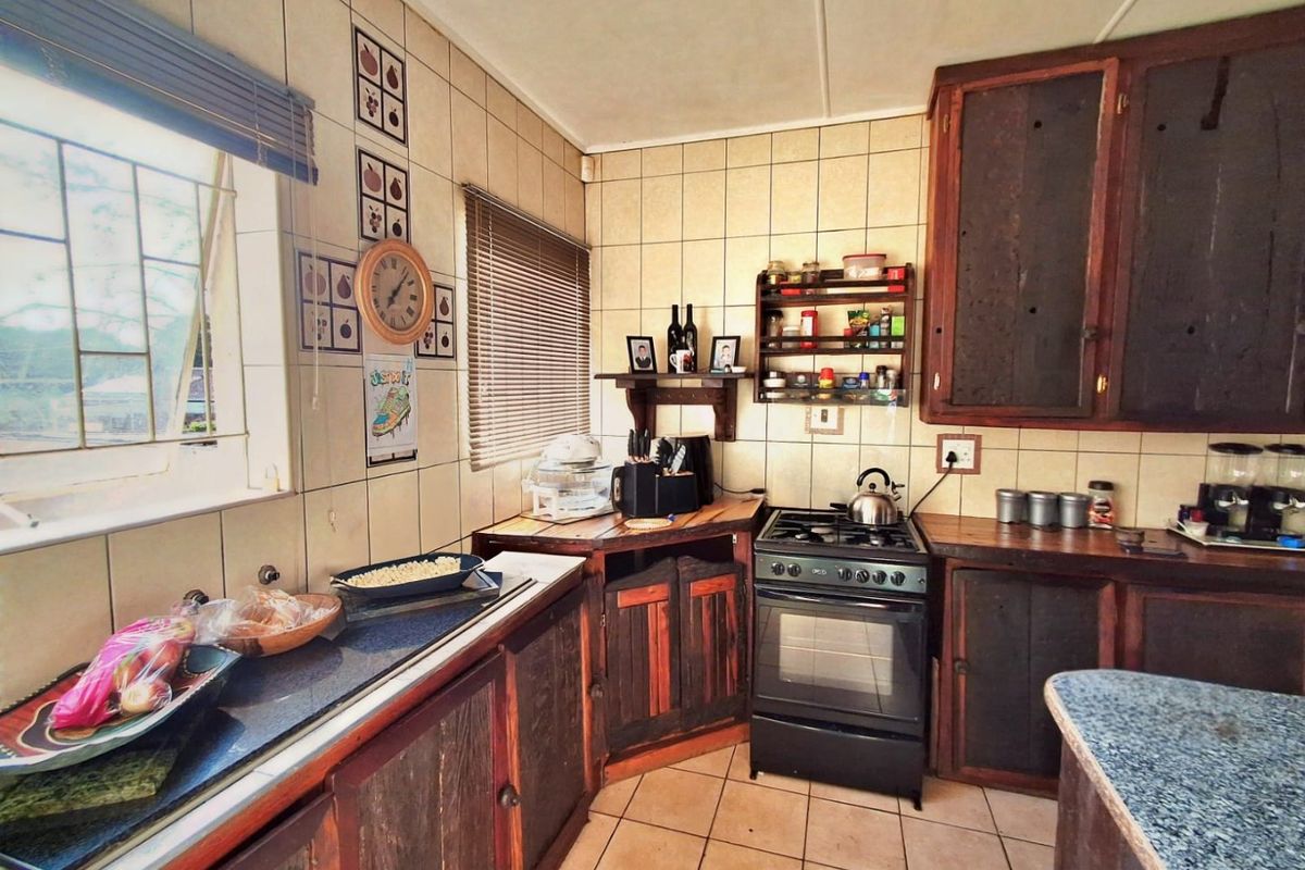 A dated kitchen featuring wooden cabinetry, tiled backsplash, and a built-in gas stove with oven, offering potential for a modern renovation.