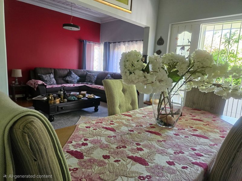 Open plan living and dining area featuring ornate ceiling cornicing and direct access to the exterior through a security gate.