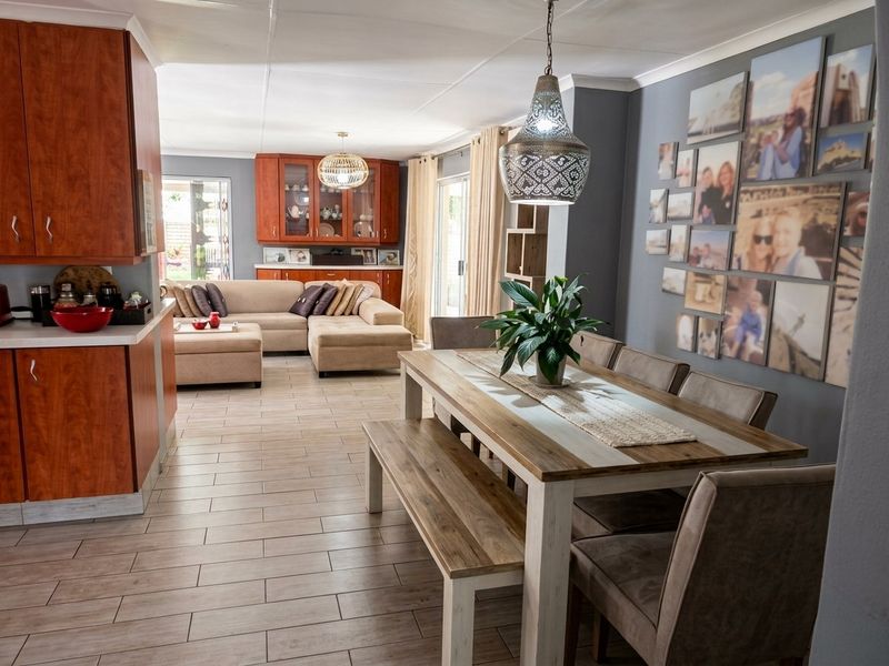 Spacious open-plan living and dining area featuring tiled floors, built-in cabinetry, and direct access to the outdoor space through sliding glass doors.