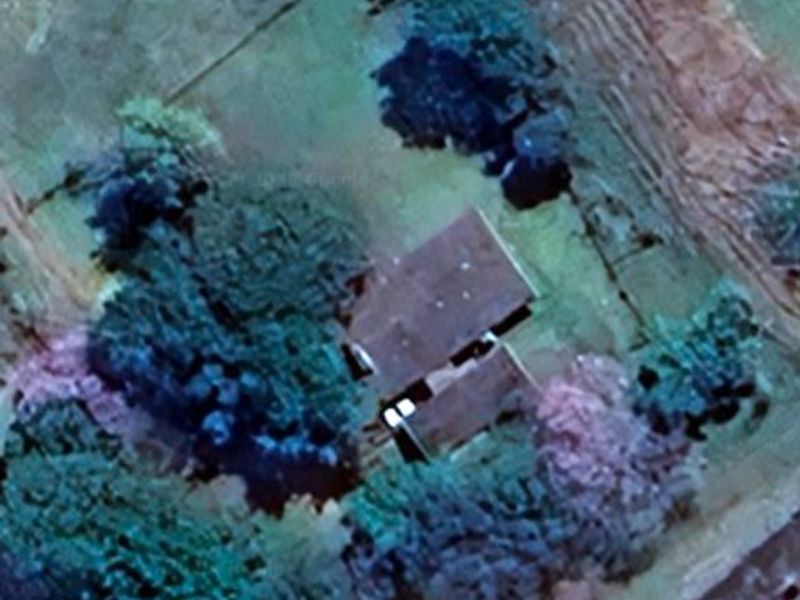 An aerial view of the property showing the roof structure and surrounding grounds.
