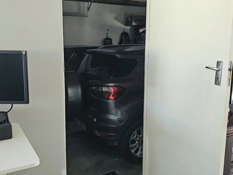 A view from an interior living space looking through an open doorway into an attached garage area.