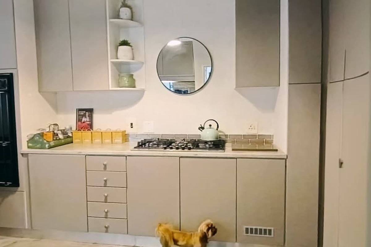Modern kitchen featuring light grey cabinetry, a built-in oven, gas hob, and a stylish subway tile backsplash.