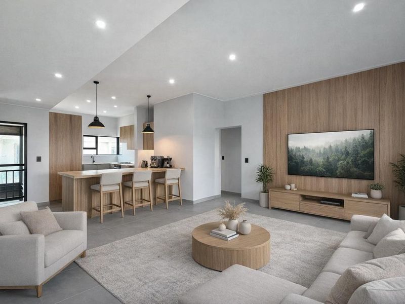 Modern open-plan living area featuring a sleek kitchen with island, wood-paneled feature wall, and contemporary recessed lighting throughout the spacious interior.
