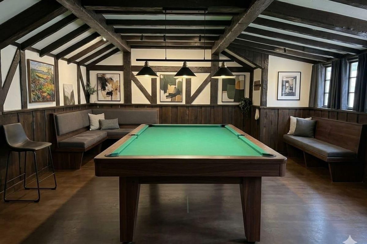 A well-appointed games room featuring exposed timber ceiling beams, dark wood wall paneling, and integrated bench seating, creating a sophisticated and cozy atmosphere.