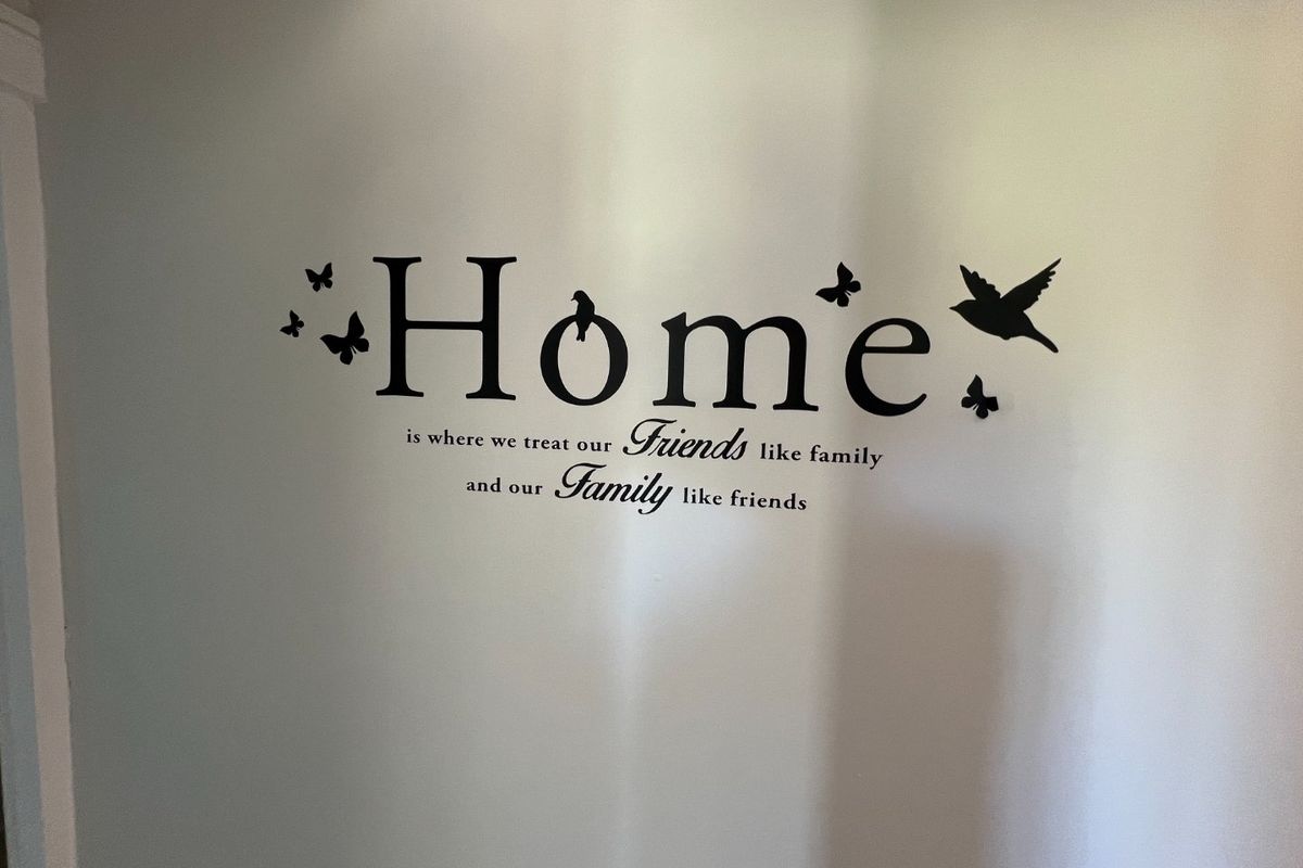 A plain interior wall featuring decorative wall decals.
