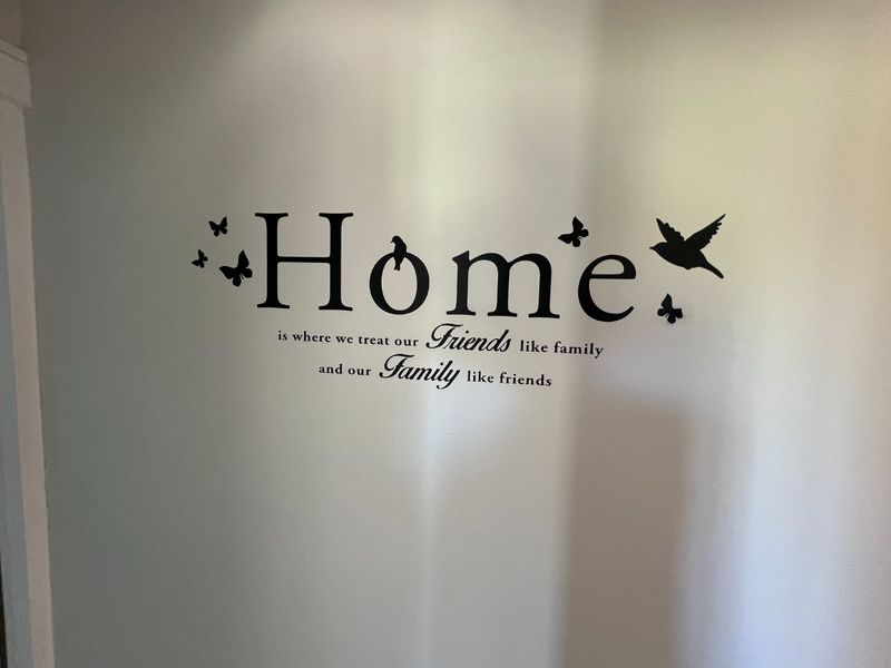A plain interior wall featuring decorative wall decals.