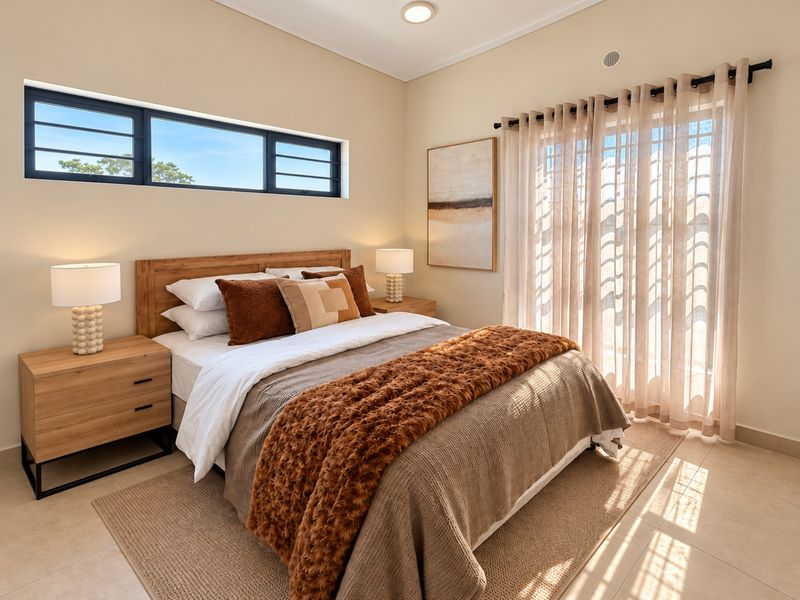 A well-lit, modern bedroom featuring tiled floors, a horizontal window, and a sliding glass door with curtains, providing natural light and outdoor access.