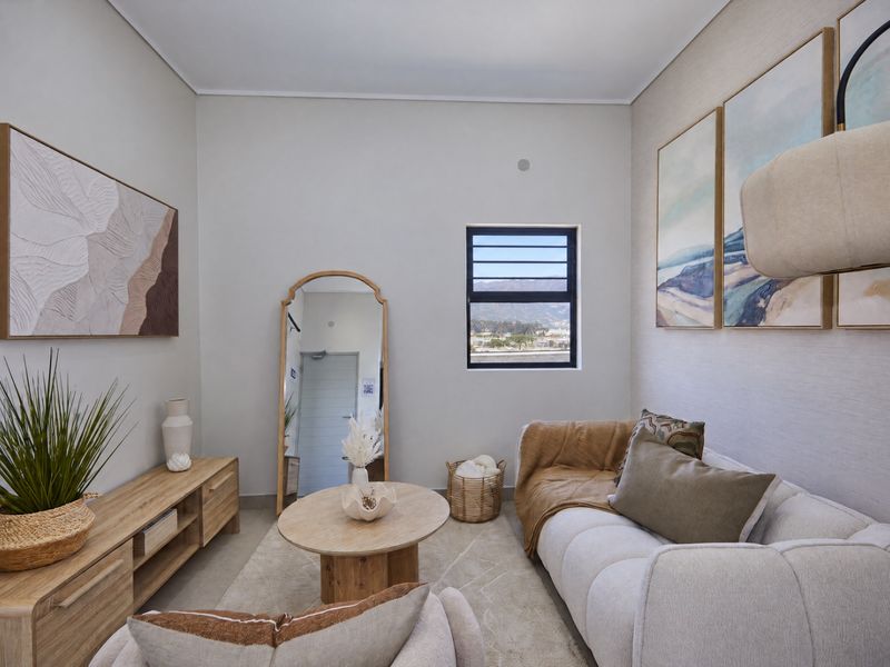 A well-lit, modern living room featuring textured wallpaper and a louvered window with scenic views.
