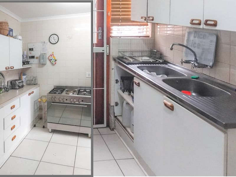 A functional kitchen featuring white cabinetry, a gas stove, and a double bowl sink with tiled splashbacks and flooring.