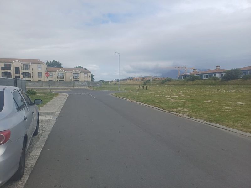 A view of the residential street approach showing the surrounding neighbourhood infrastructure and road access.