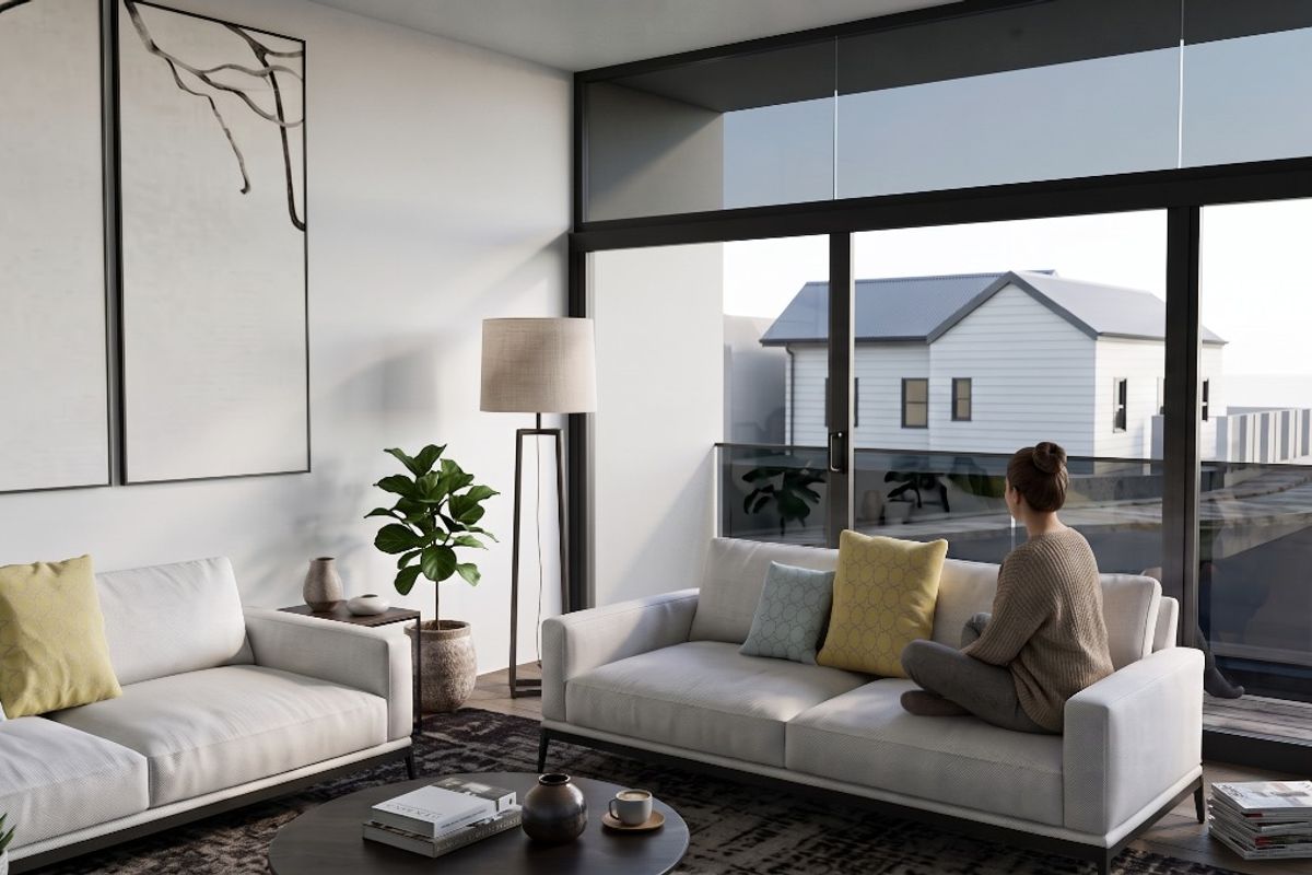 Modern living room featuring expansive floor-to-ceiling sliding glass doors that provide seamless access to an outdoor balcony area.