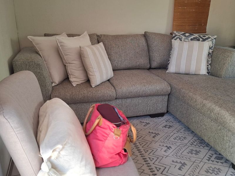 A cozy living room area featuring neutral wall finishes and a functional layout suitable for relaxation.