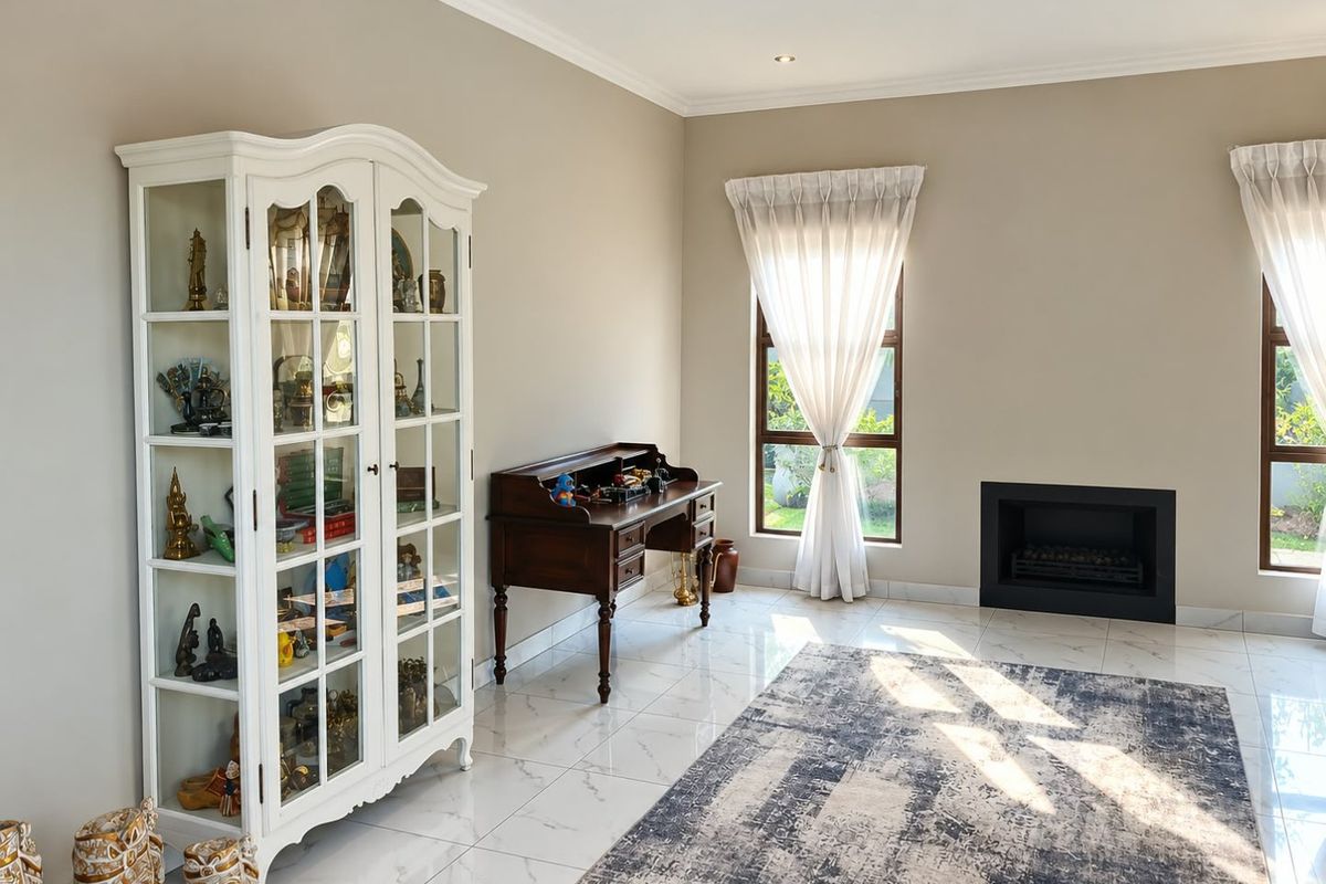 A bright living room featuring polished tiled flooring, a modern built-in fireplace, and large windows with natural light.