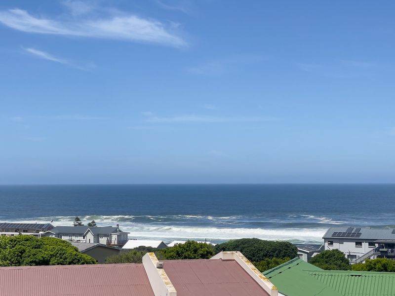 A clear, elevated view overlooking the surrounding neighbourhood towards the ocean and coastline.